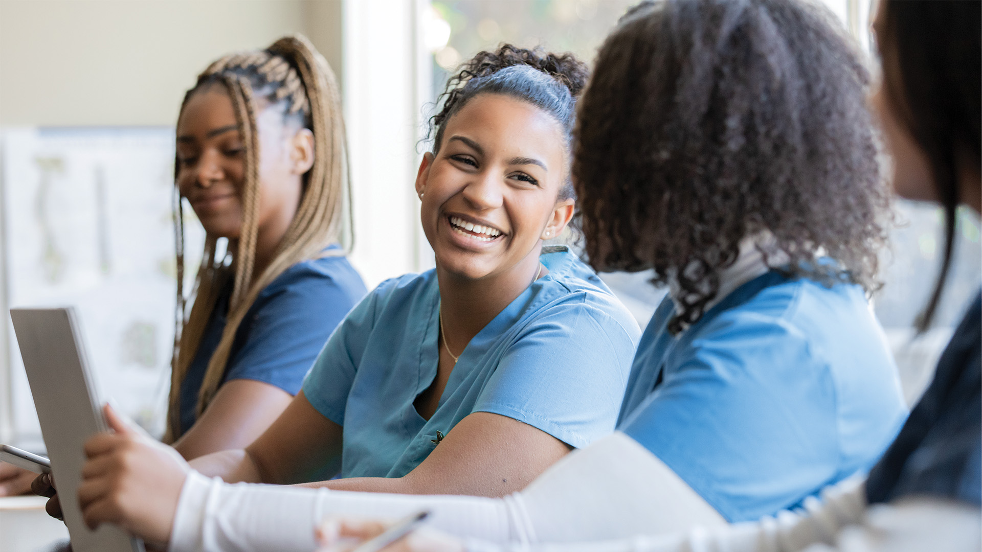 medical assistant students sitting in a classroom talking